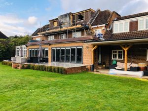 Ongoing home renovation with scaffolding and loft conversion work, highlighting the complexity of renovating older properties in 2025