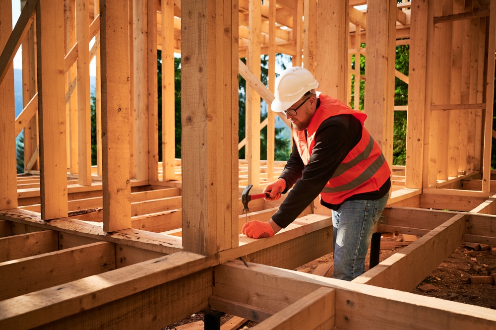 Builder in Reigate installing timber frame structure on residential construction project