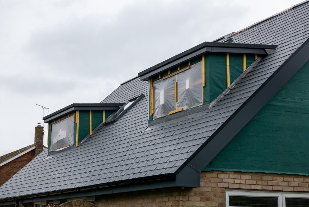 Dormer loft conversion in progress with new roof structure and insulation installed