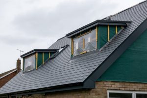 Dormer loft conversion in progress with new roof structure and insulation installed